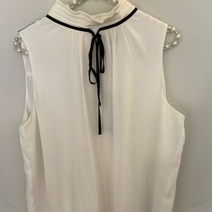Karl Lagerfeld cream blouse with black tie in front.